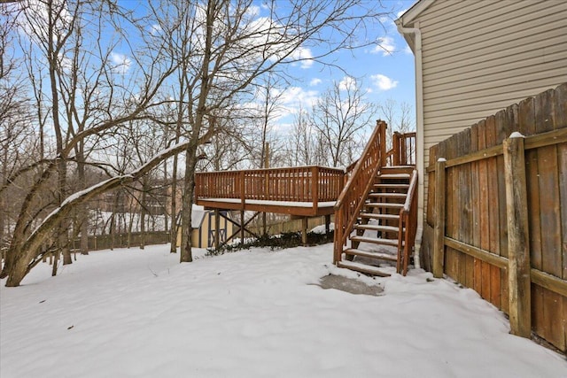 yard layered in snow with a deck