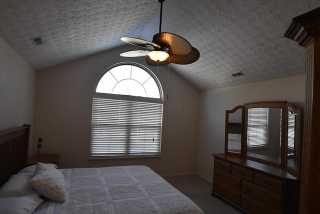 bedroom featuring a textured ceiling, carpet floors, vaulted ceiling, and ceiling fan