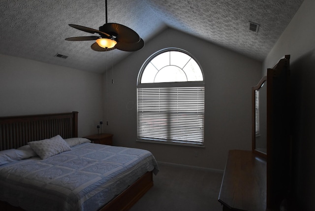 bedroom featuring ceiling fan, dark carpet, lofted ceiling, and a textured ceiling