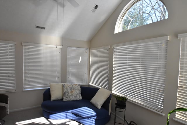 living room featuring ceiling fan and vaulted ceiling