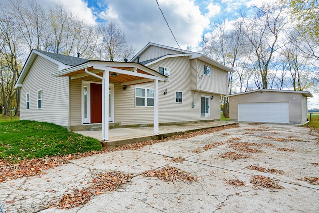 view of front of house with an outbuilding, a porch, and a garage