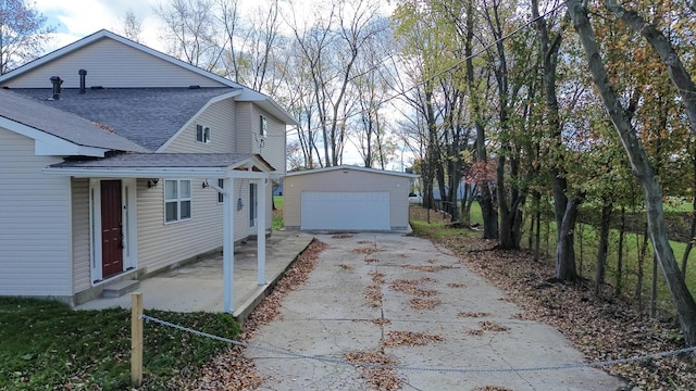 view of side of home with a garage and an outdoor structure