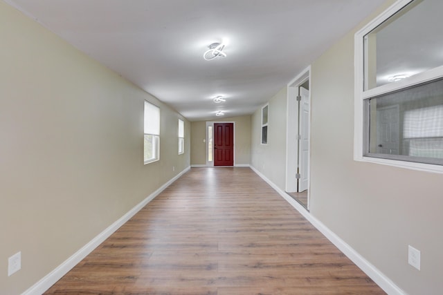 hallway with hardwood / wood-style floors