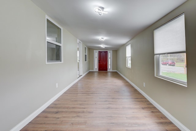 hallway with light hardwood / wood-style flooring