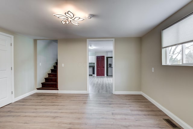 spare room with light wood-type flooring