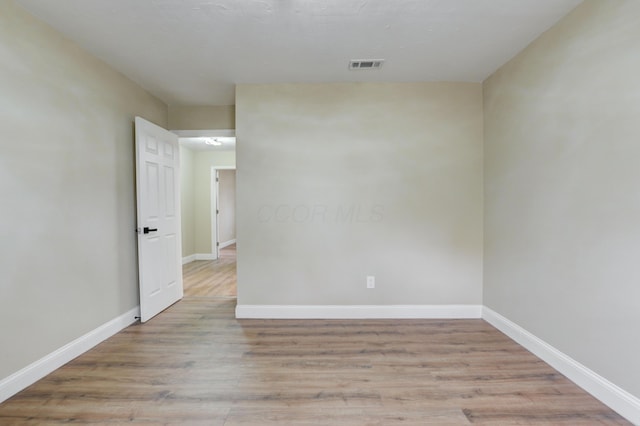 empty room with light hardwood / wood-style floors