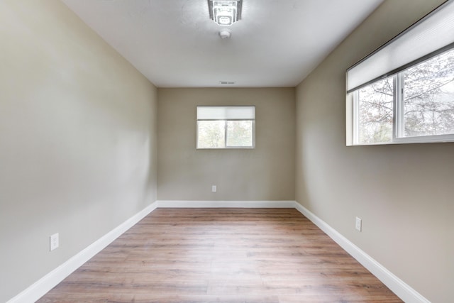 unfurnished room with light wood-type flooring