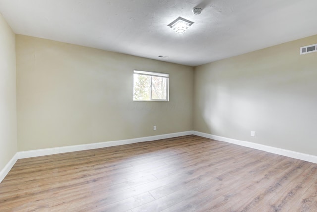 unfurnished room featuring light hardwood / wood-style floors