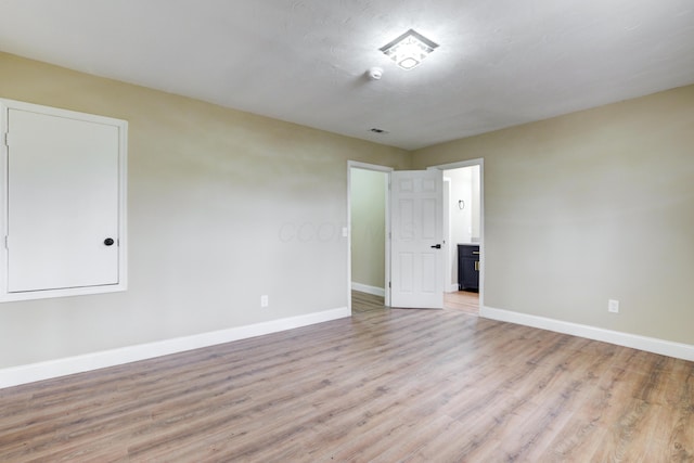 unfurnished room featuring light wood-type flooring