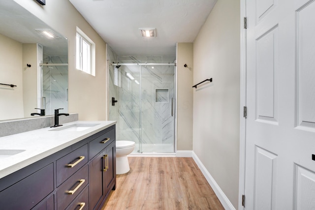 bathroom featuring an enclosed shower, vanity, toilet, and wood-type flooring