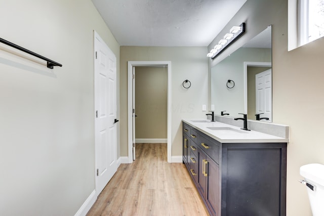 bathroom featuring hardwood / wood-style floors, vanity, and toilet