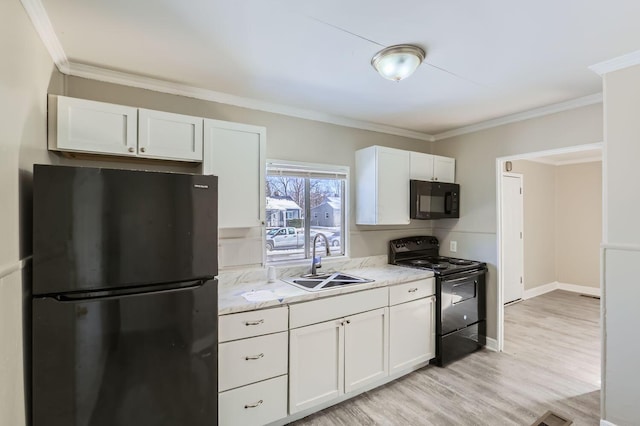 2573 Howey Rd, Columbus, OH 43211 - kitchen featuring sink, crown molding, black appliances, light hardwood / wood-style floors, and white cabinets