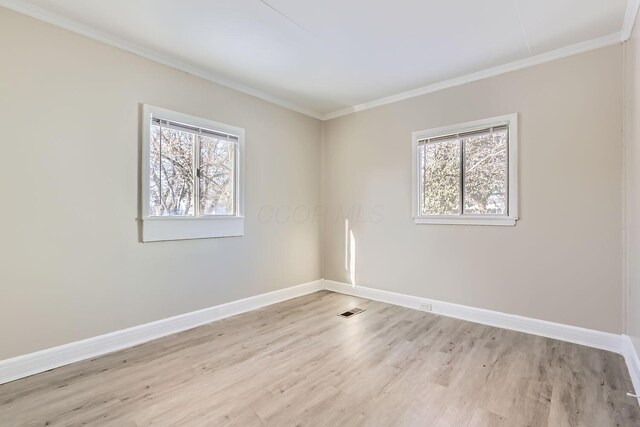 2573 Howey Rd, Columbus, OH 43211 - spare room with ornamental molding, a wealth of natural light, and light hardwood / wood-style floors
