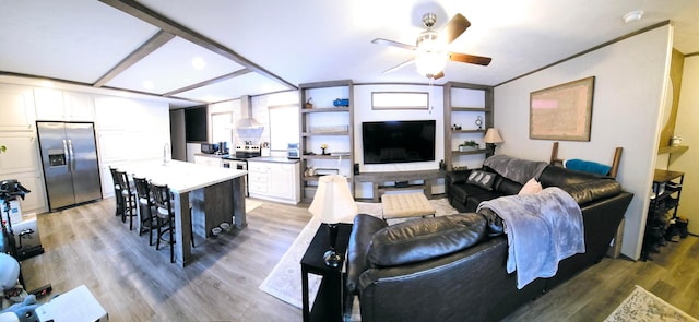 living room featuring wood-type flooring and ceiling fan