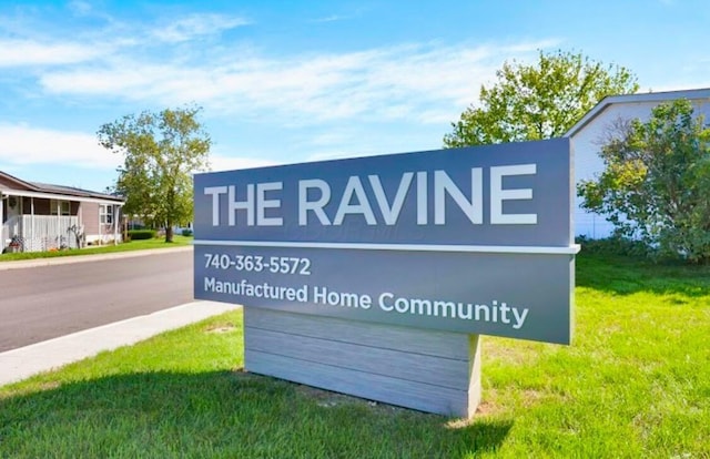 community sign featuring a lawn