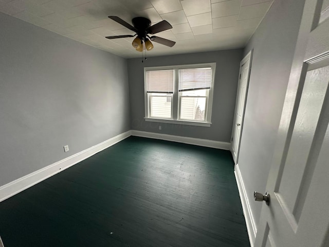 spare room with ceiling fan and dark wood-type flooring