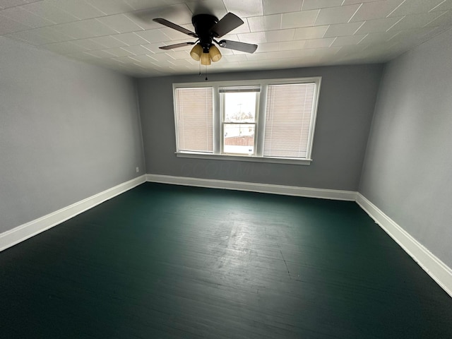 empty room with ceiling fan and dark hardwood / wood-style flooring