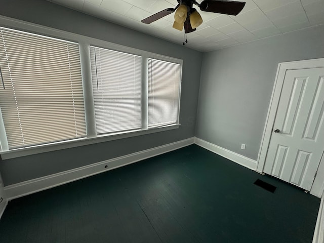 spare room with ceiling fan and dark hardwood / wood-style flooring