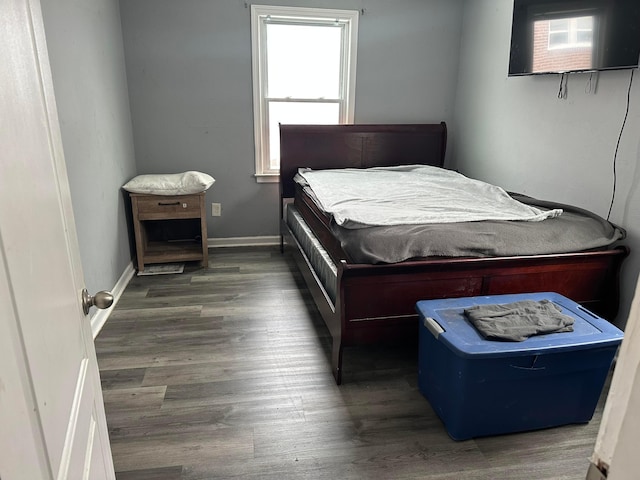 bedroom with dark wood-type flooring