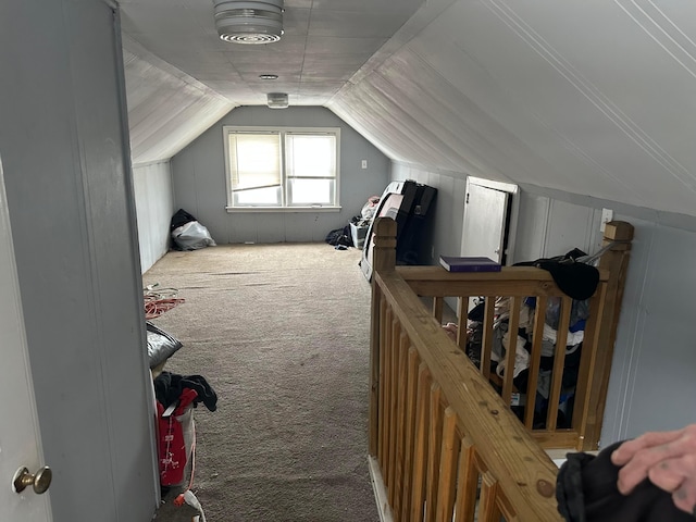 interior space featuring lofted ceiling and carpet flooring