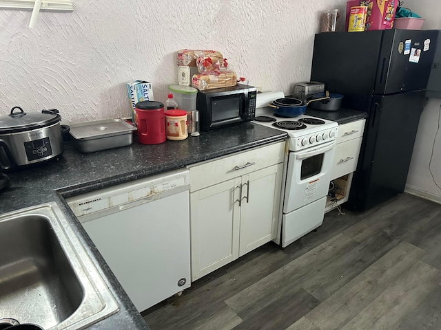 kitchen with sink, dark hardwood / wood-style floors, and black appliances