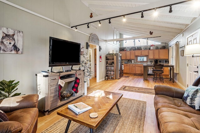 living room with high vaulted ceiling, rail lighting, light wood-type flooring, beam ceiling, and wood ceiling