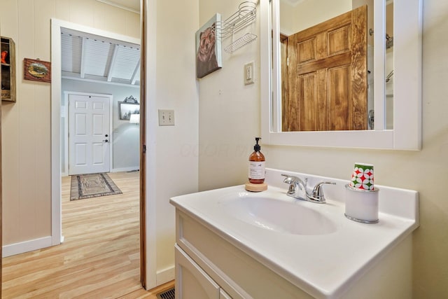 bathroom with vanity and hardwood / wood-style flooring