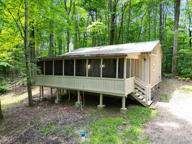 view of front of house featuring a sunroom