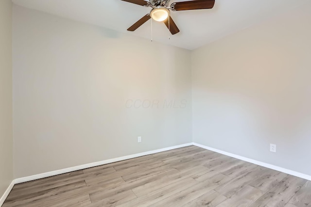 spare room with ceiling fan and light wood-type flooring