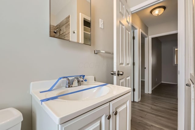 bathroom with vanity, wood-type flooring, and toilet