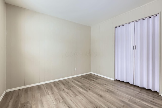 spare room featuring light hardwood / wood-style flooring