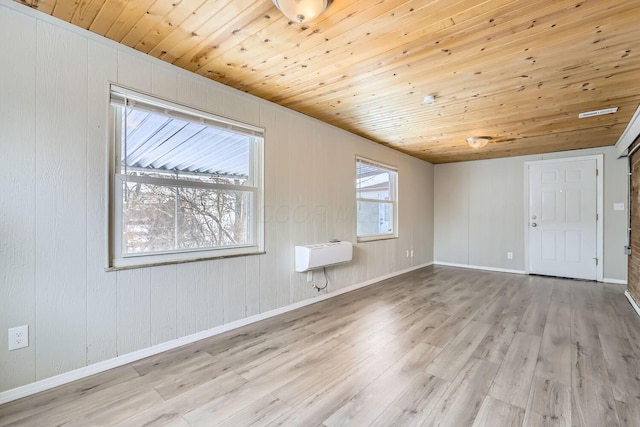 interior space featuring wood ceiling, light hardwood / wood-style flooring, and an AC wall unit