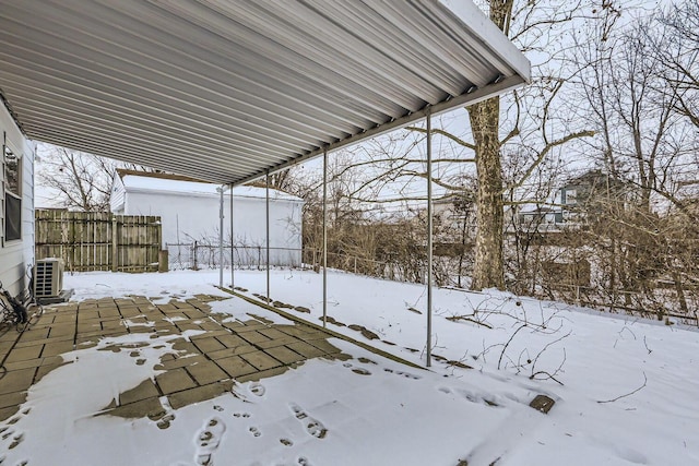 snowy yard featuring ac unit