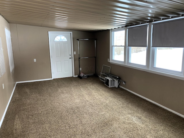 entryway with carpet floors and wooden ceiling