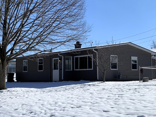 view of snow covered back of property