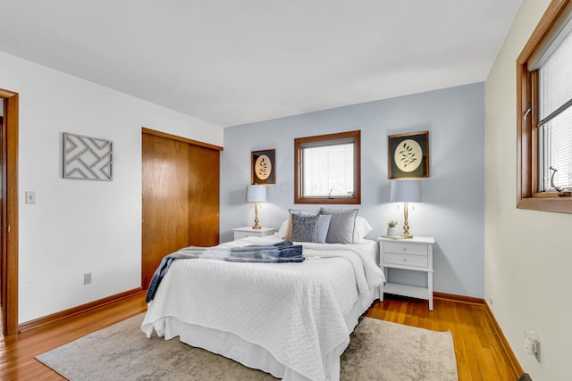 bedroom with a closet and light hardwood / wood-style flooring