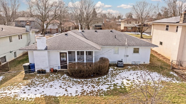 snow covered property with central air condition unit