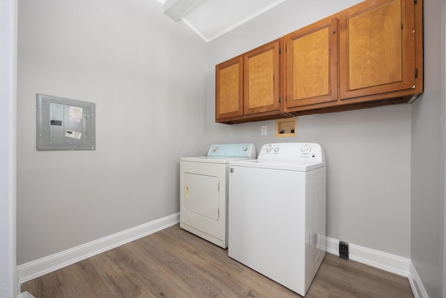 laundry area with cabinets, separate washer and dryer, electric panel, and light hardwood / wood-style flooring