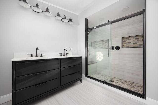 bathroom with vanity, an enclosed shower, and a textured ceiling