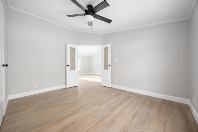 spare room with crown molding, ceiling fan, and light wood-type flooring