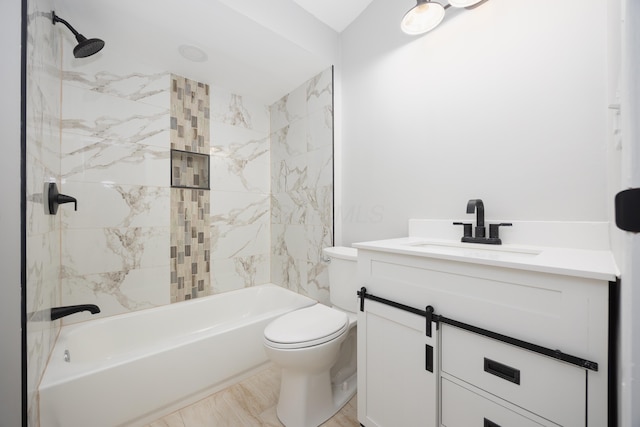 full bathroom featuring vanity, toilet, and tiled shower / bath