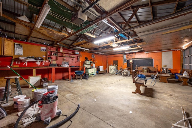 garage with a workshop area and a garage door opener