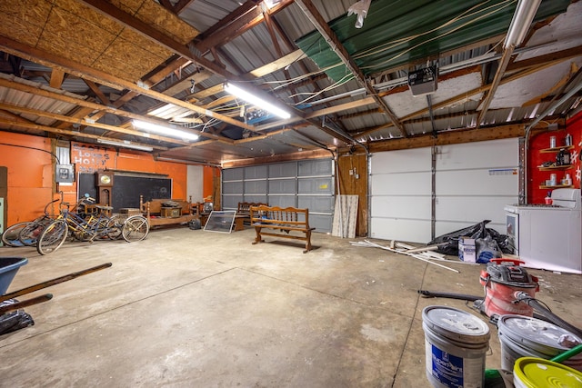 garage with a garage door opener and washer / clothes dryer