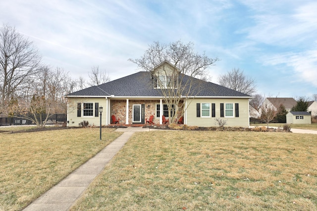 view of front facade with a shed and a front lawn