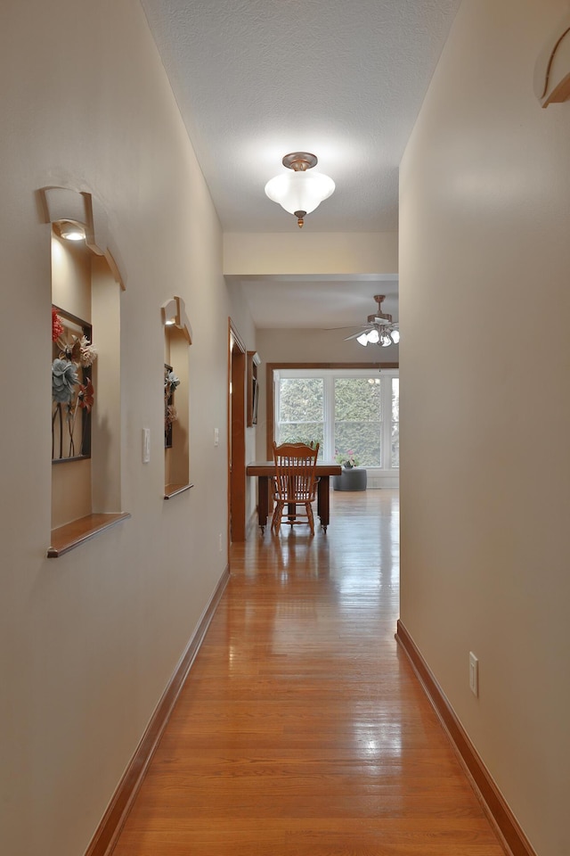 corridor with light hardwood / wood-style flooring