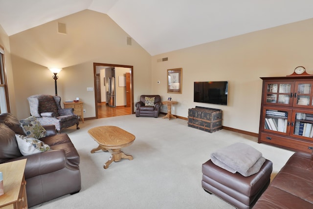 living room with carpet floors and high vaulted ceiling