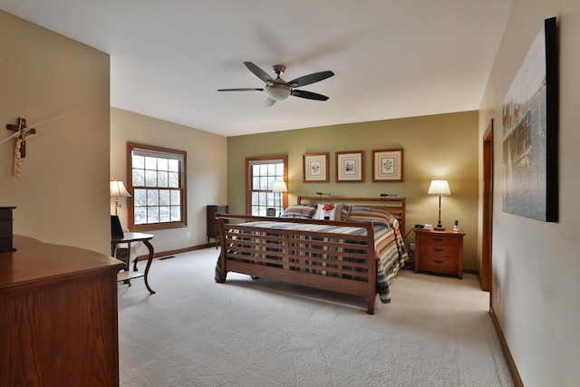 bedroom with light carpet and ceiling fan