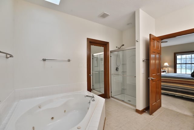 bathroom featuring tile patterned flooring, a skylight, and shower with separate bathtub