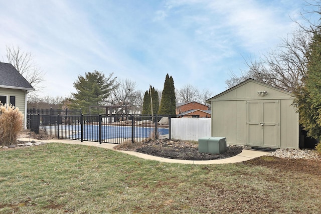 view of pool featuring a lawn and a storage unit