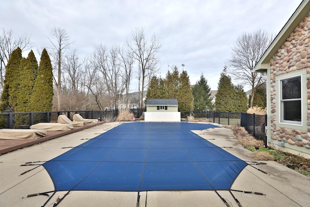 view of pool with an outbuilding and a patio area